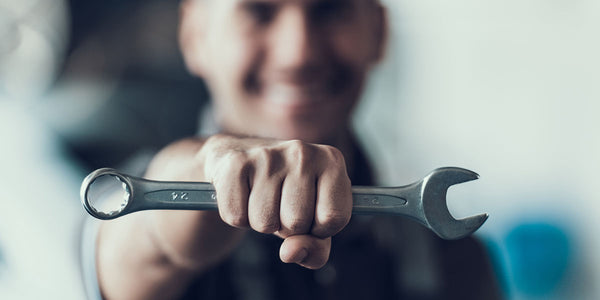 technician holding a wrench to represent Coffee Equipment Pros' service technician network Tek-Net and Tek-Paks