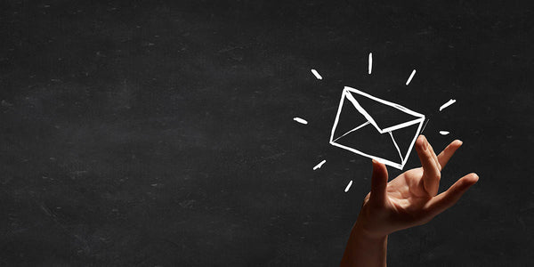 Image of hand holding an envelope at top of page for Coffee Equipment Pros' e-newsletter signup page