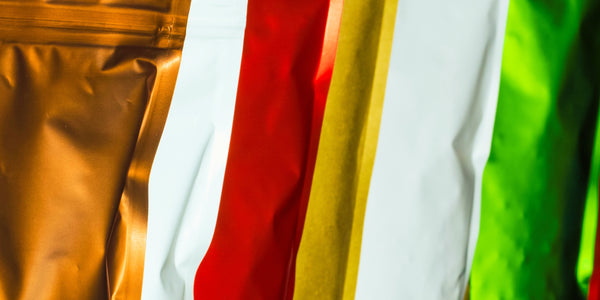 Image of multiple coffee bags symbolizing different packaging options in Coffee Equipment Pros' buyers guide
