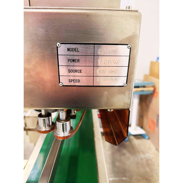 Plate detail of 2023 Youlian QLF-1680 vertical band coffee bag sealer, used coffee equipment in excellent condition, ready for high-volume packaging.