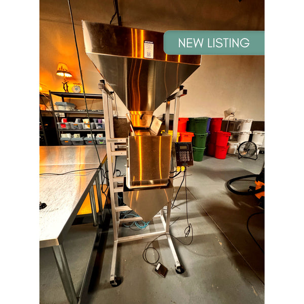 2024 Logical S-4 used coffee weigh-and-fill machine with stainless steel hopper beneath a green “NEW LISTING” banner.