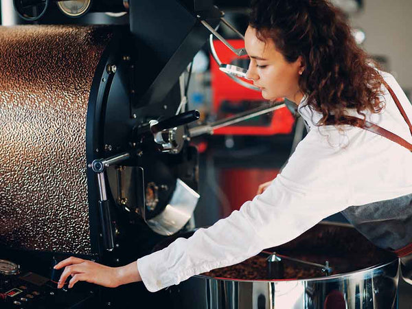 woman operating a coffee roaster